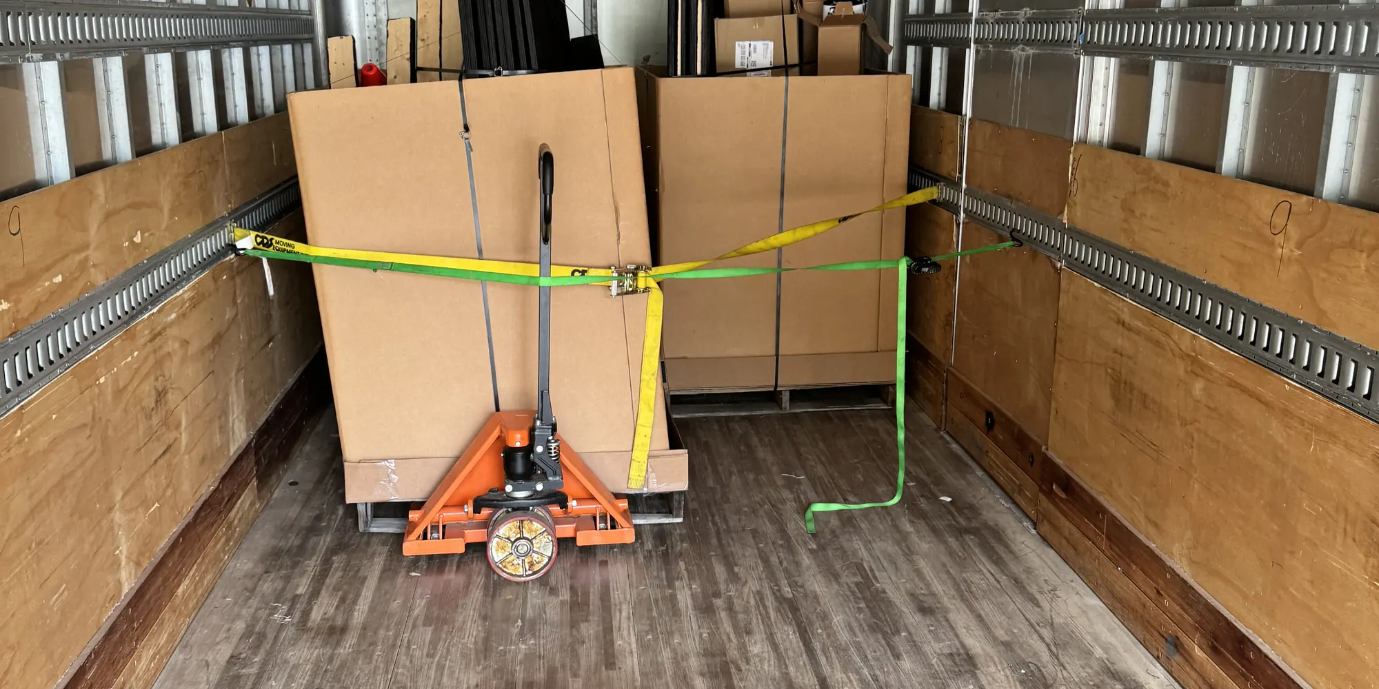 Palletized freight strapped and secured inside a Quest box truck