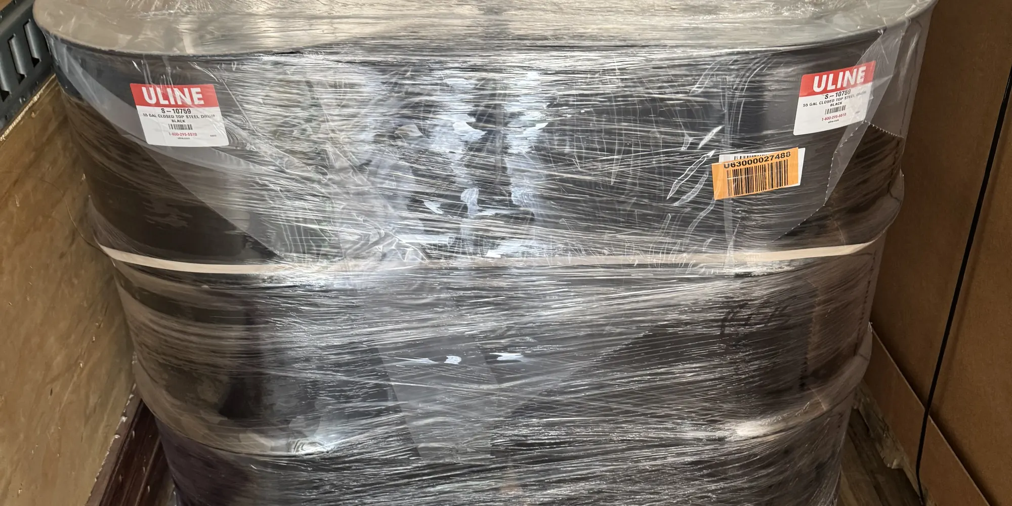 Shrink-wrapped pallet of steel drums loaded for delivery